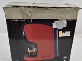 the box is open to show the contents of the coffee maker