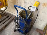 a blue bucket with a yellow handle next to a pallet