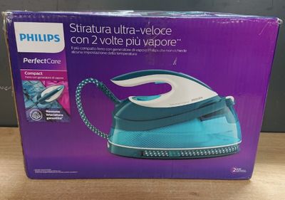 the box of a blue and white steam iron sitting on a table