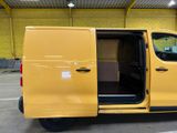 the yellow van is parked in the parking lot with its doors open