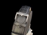 the watch is black and silver with a silver buckle on the strap