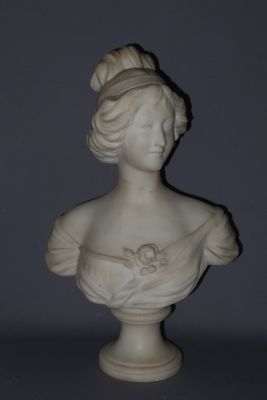 a white busturine of a woman with a flower in her hair