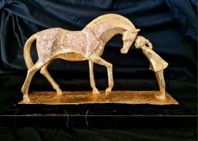 statue of a horse and a woman on a black background