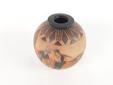 a small vase with a design on it on a white surface
