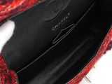 the inside of a red and black handbag with spikes on it