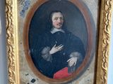 portrait of a man in a black coat and red pants in a gold frame