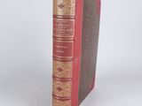 a red book that is sitting on a white surface