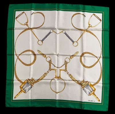 a green and white scarf with gold scissors and chains on it