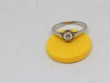 a close up of a diamond ring on a yellow sponge