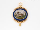 a picture of a sheep in a blue and gold broochle