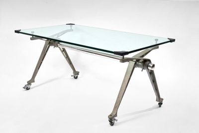 an image of a glass table with metal legs and a glass top