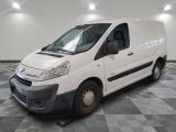 the white van is parked in a large room with a checkered floor