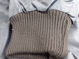 a pair of gloves that are on top of a bed