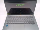 a silver laptop with a black keyboard on a white surface