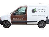 the van is parked on the side of the road with its door open