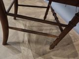 a wooden chair that is sitting on a hard wood floor