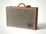 an old louis vuitton suitcase sitting on a white surface