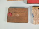 a small wooden box with a red string on top of it