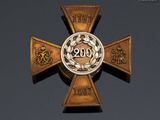 a close up of a cross with a medallion on it