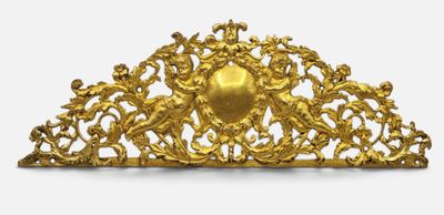 a gold piece with angels on it on a white surface
