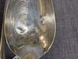 a silver spoon with a tag on it sitting on a table