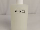 a close up of a bottle of white liquid on a white surface