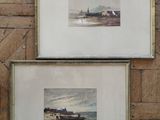 two framed pictures of boats on a wooden wall next to a clock