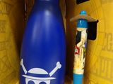 a blue bottle with a skull and crossbone on it in a cardboard box
