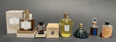 several bottles of perfume sitting next to each other on a table
