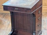 a wooden desk with a marble top on a hard wood floor