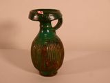 a green vase with a red tag on it