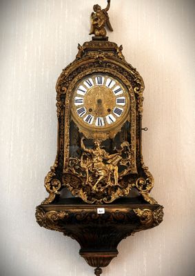 a clock hanging on the wall with a bird on it