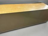 a large metal box with a wooden top on a grey background