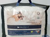 a close up of a bed with a bag on top of it