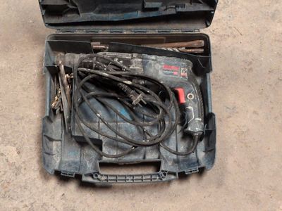a tool case with tools inside of it on the ground