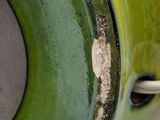 a close up of a green vase with a hole in it