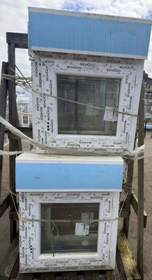 two microwaves stacked on top of each other on a pallet