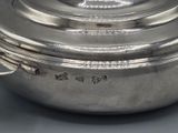 a large silver pot with a lid on a table