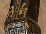 a close up of a clock on a wooden table