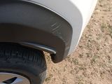 a close up of a tire on a white car