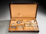 a wooden box with silverware in it on a table