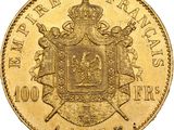 a close up of a gold coin with a crown on it