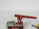 a toy truck with a crane attached to it ' s back
