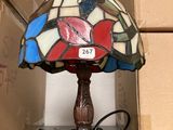 a lamp that is sitting on a table next to a box