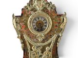 a gold clock on a white background with a white background