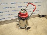 the vacuum is sitting on the floor in front of the wall