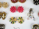 many different types of jewelry on a white surface
