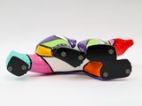 a colorful motorcycle that is sitting on a white surface