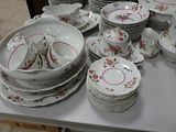 a lot of plates and bowls on the table