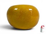 a yellow apple that is sitting on a white surface